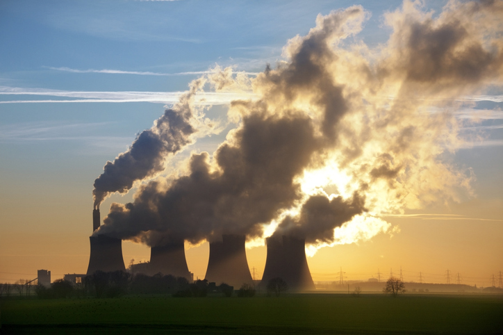 Smoke from power station chimneys, illustrating the environmental impact of AI
