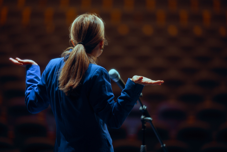 A public speaker shrugs