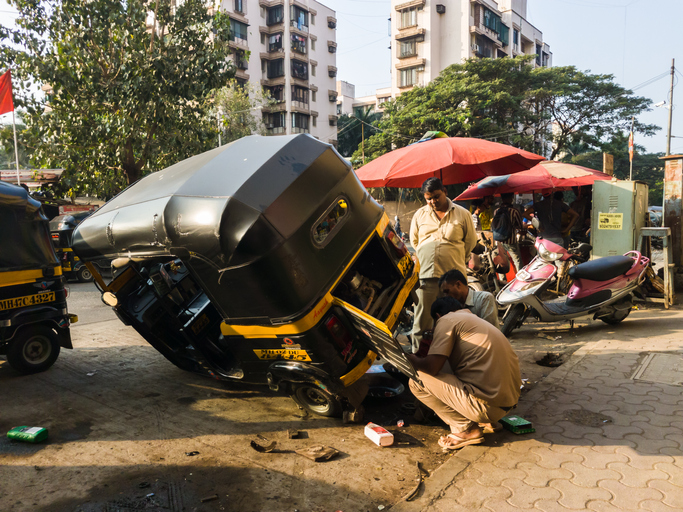 A rickshaw wheel is repaired