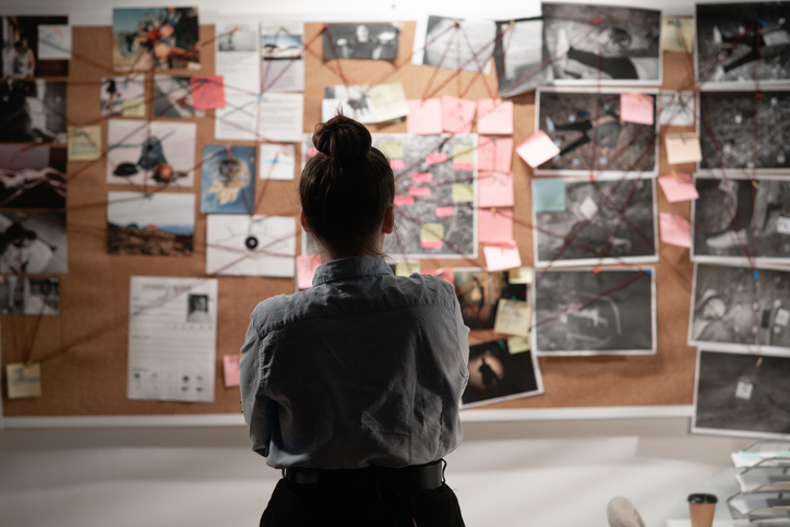 A detective studying an investigation board, symbolising data sleuthing