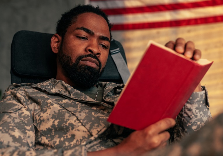 A soldier reading a book