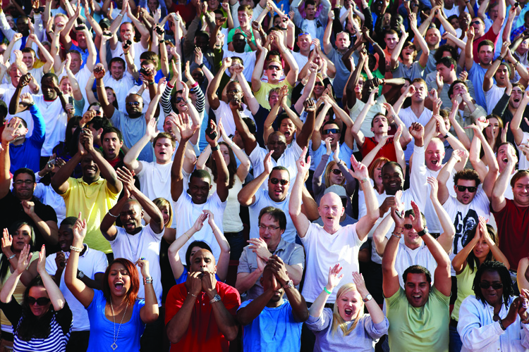 Crowd of people clapping and cheering