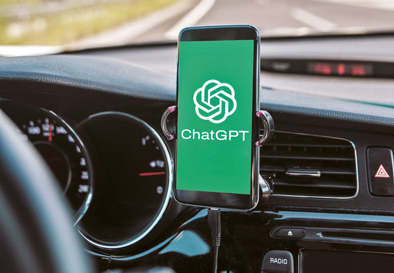 Montage of a mobile phone inside a car with ChatGPT on the screen to illustrate As a learning satnav, ChatGPT puts students on road to success