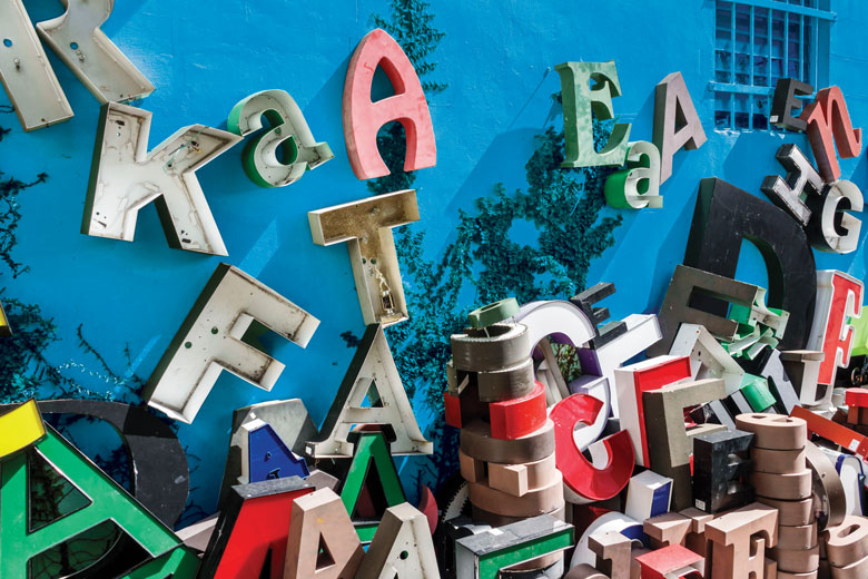 Giant letters scattered and stacked up along a building to illustrate Sloppy writing, sloppy science
