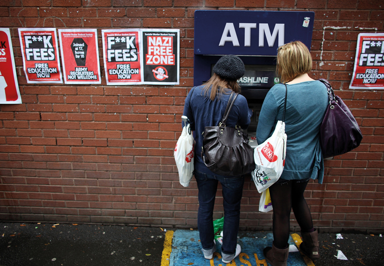 Students arriving for Manchester University's freshers week queue up at a cash machine in Manchester, England.
