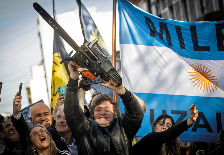 Presidential candidate Javier Milei of La Libertad Avanza lifts a chainsaw next to Buenos Aires province governor candidate