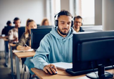 Students sitting university admissions tests on computers