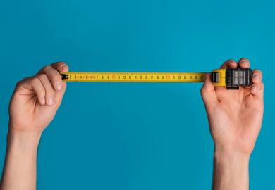 Child holding up measuring tape