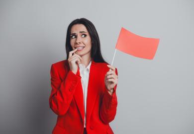 Worried-looking woman waves red flag