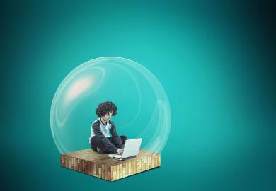 Man at laptop, sitting inside and oversized bubble
