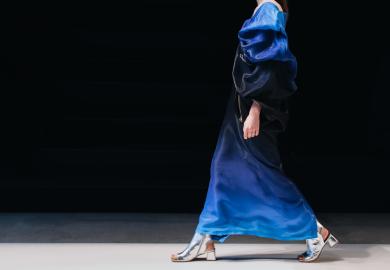 Model walks down catwalk