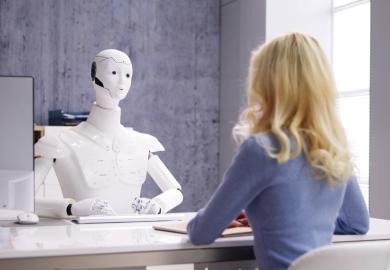 Student at desk, being interviewed by a robot
