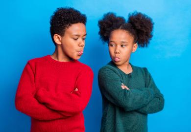 Two children, sticking tongues out at one another