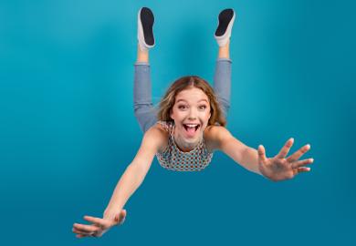 Smiling student falling through the air