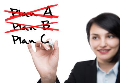 Woman crossing out the words "Plan A" and "Plan B" and writing "Plan C"