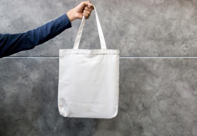 Hand holding tote bag