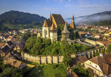 Town in Romania, viewed from above, with hills in the background