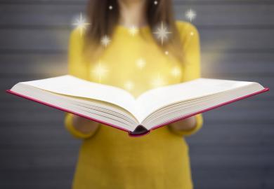 Student holding open blank book, from which stars emerge