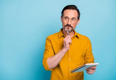 Man with notepad and pen, thinking