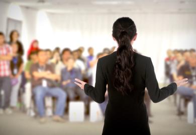 A female speaker addressing a conference