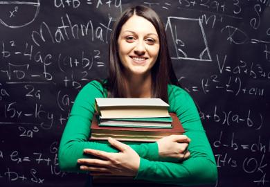 A female student holding a pile of books