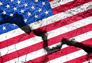 An American flag with a big crack through it