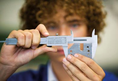 An apprentice with a caliper