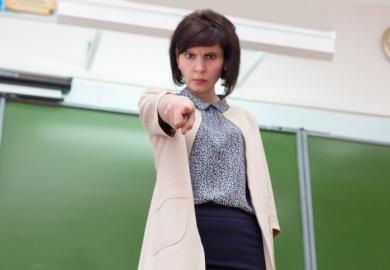 A teacher points angrily
