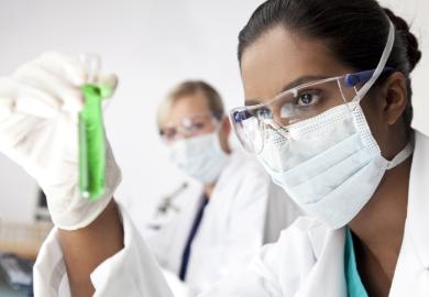 An Asian scientist holding a test tube