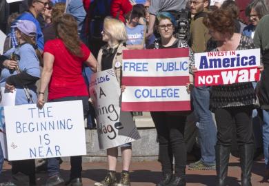 Bernie Sanders supporters with a free college sign