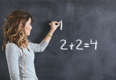 woman writes on blackboard