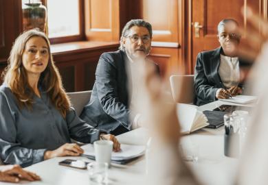 Board members listen to someone speaking