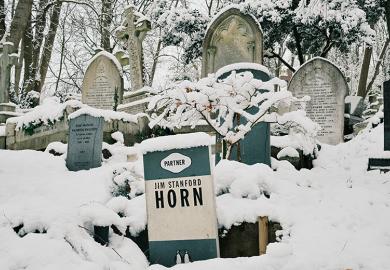The gravestone of Jim Stanford Horn shaped like a book by Penguin Books publishing house is covered in snow at Highgate Cemetery on 12 December, 2022 in London, England. To illustrate that reading is dying out on UK campuses.