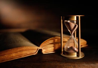 An old book next to an hourglass, symbolising English literature