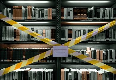Books on taped-off library shelf