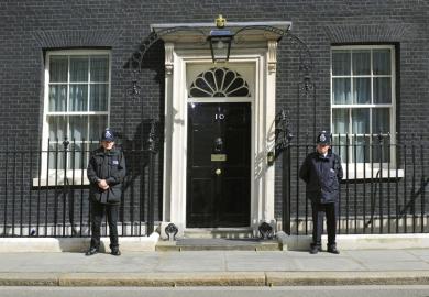 British police officers guarding 10 Downing Street entrance, London