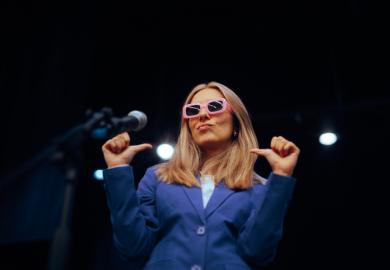 A woman in pink glases points to herself, illustrating showing off on socail media