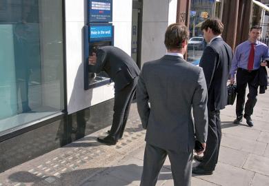 Business men at ATM
