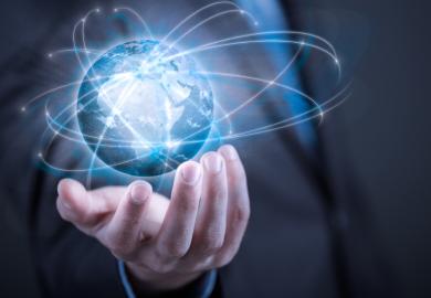 Businessman holding planet Earth in palm
