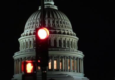 The US capitol building with a red traffic light in front of it, illustrating democracy under threat