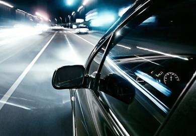 Car driving quickly into European motorway fast lane