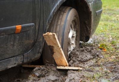 A car wheel stuck in a rut