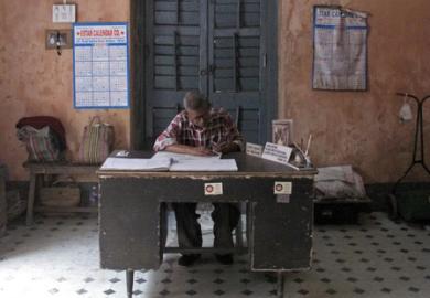 A clerk sits at his desk