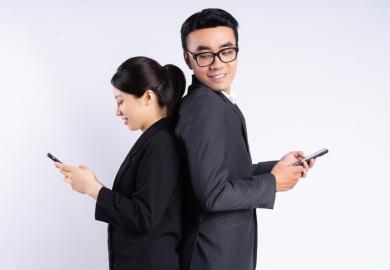 Two Asian business people on their phones