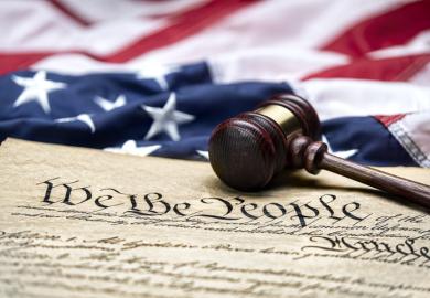 The US constitution, with a gavel next to it
