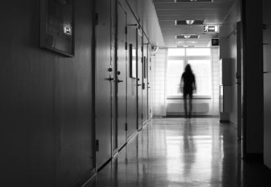A woman leaving a corridor