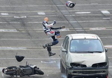 Car hits human dummy on scooter