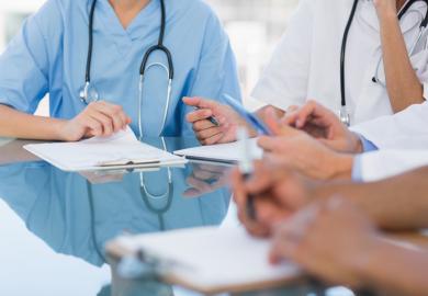 Doctors in a meeting symbolising disagreements about healthcare education