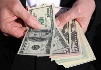 A person holding US dollars