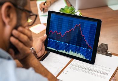 A researcher examines a downward trending graph